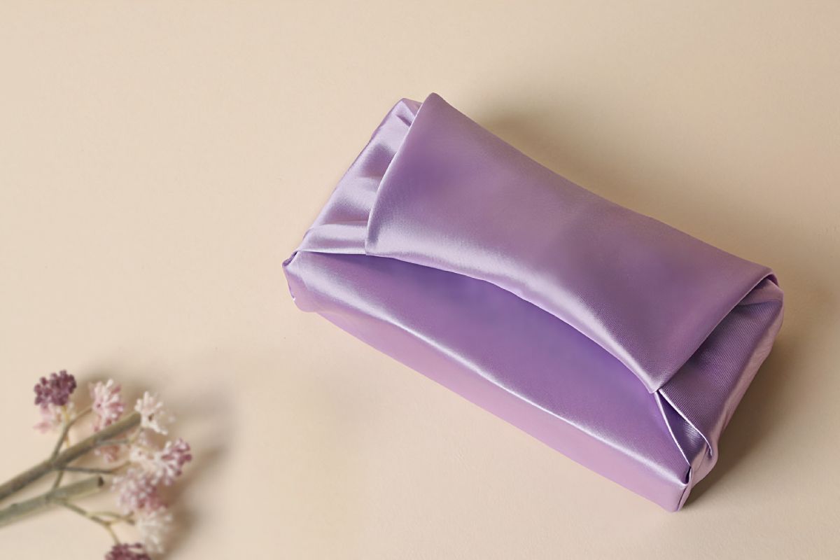 a box wrapped with light purple color Bojagi.