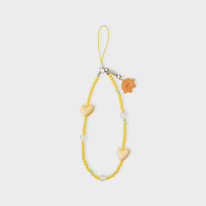 yellow phone strap with bt21 shooky face and beige heart back