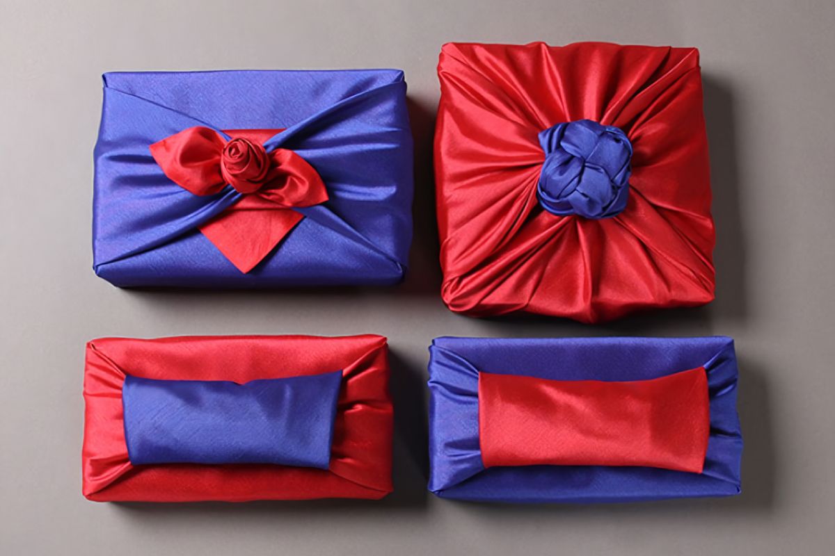 four quadrangle boxes wrapped with red and blue color Bojagi.